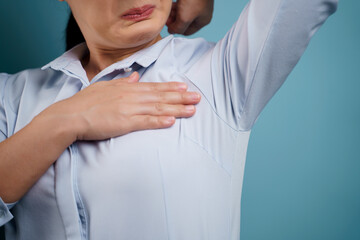 Close up shot of woman testing smelling her armpit.
