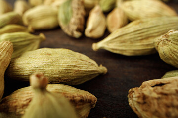 Сardamom spice bunch on wooden table macro