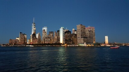 Fototapeta na wymiar Manhattan financial district from Staten Island Ferry at dusk