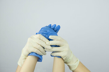 Human holding Variation of Latex Glove, Rubber glove manufacturing, human hand is wearing a medical...