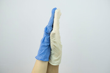 hands in rubber medical gloves raised up close up