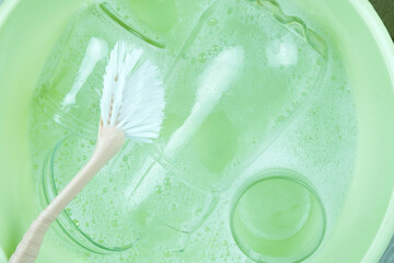 white unwashed dishes in the bubbly water