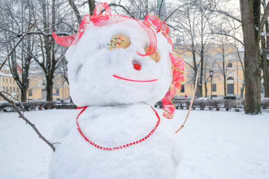 snow figure - funny woman, babushka on winter snowy day after snowfall