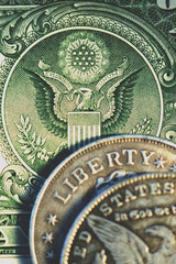 Close up one Dollar bill and coins. Vertical image.