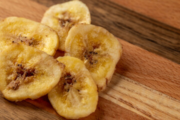 Dried banana slices on a wooden board