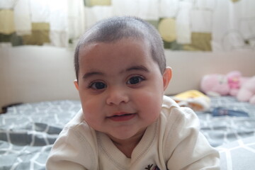 Baby girl with lovely face, big eyes and cute face gesture