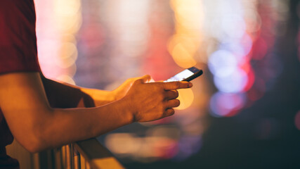 Hands using smartphone on night city