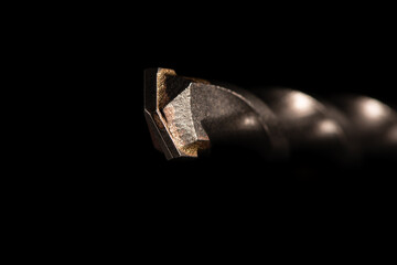 A heavy professional drill bit for concrete drilling and demolition on a black background.