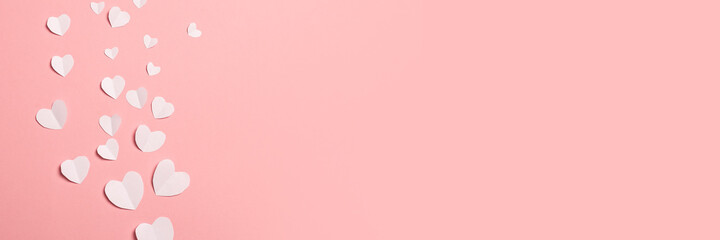 White paper hearts on a pink background. Composition of Valentine's Day. Banner. Flat lay, top view