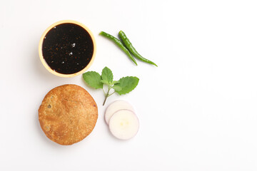 Kachori, green chilly and khatai on white background. Kachori is a spicy snack from India also spelled as kachauri and kachodi