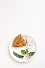 veg samosa served with green chilly chutney onion on white background
