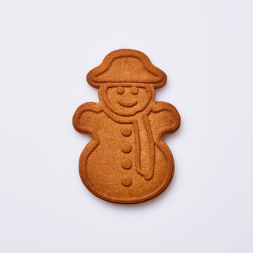 New Year gingerbread or snowman shaped cookies isolated on white background. Square image. Top view.