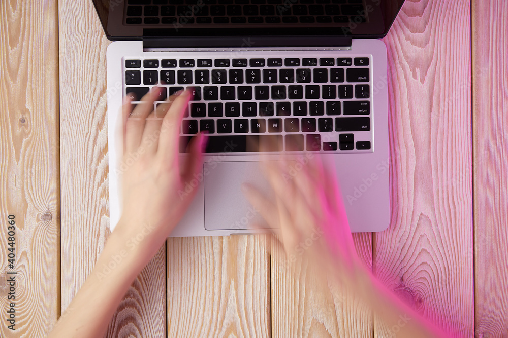 Poster Image of woman’s hands typing fast on laptop keyboard. View from above. Remote work concept image.