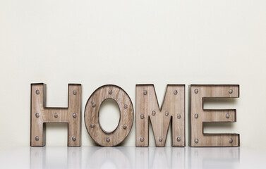  wooden letters with light bulbs with the word home, concept of home 