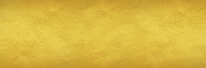 textured wall painted with gold color - wide banner or header format golden background