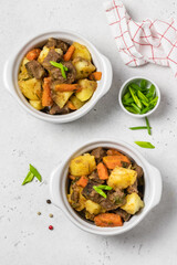 Classical roast and potatoes in pots. Top view, copy space.