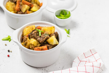 Delicious traditional  roast pork and potatoes in pots. Copy space.