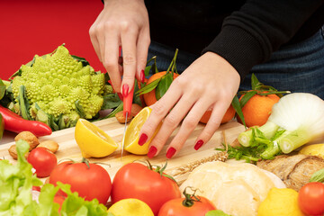 A girl is cutting a lemon on a kitchen table