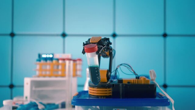 Robot arm with test tube in laboratory