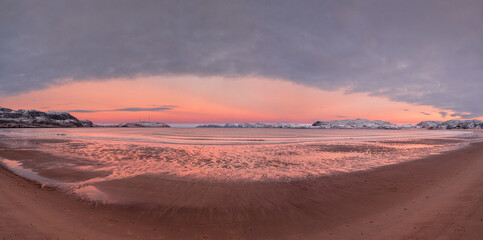 Fototapeta na wymiar Wide panoramic view of winter sunset with amazing magenta color over fjord.
