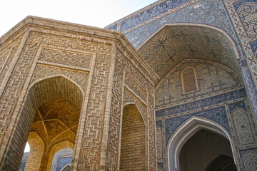 Bukhara, Uzbekistan - November 24 2019 : Poi Kalan or Po-i-Kalyan, an Islamic religious complex located around the Kalan minaret at cold weather