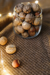 Obraz na płótnie Canvas Mix of nuts in a jar on dark background. Walnuts and pine nuts. Top view. Copy space. Superfood, vegan, vegetarian food concept. Macro of walnut texture. selective focus. Healthy snack.