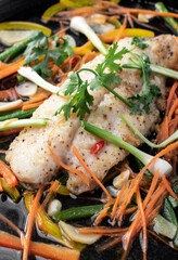 chinese style steamed fish fillet with vegetables on hot plate