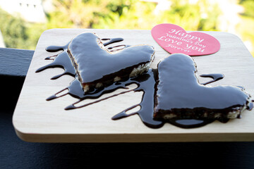 Bread topped with chocolate and red hearts with text for Valentine's Day