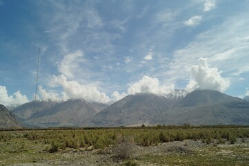 clouds over the mountains with sandy terrain