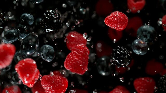 Super Slow Motion Shot of Flying Fresh Berries on Black Background at 1000fps.