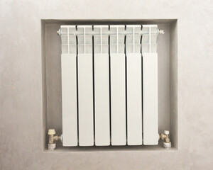 home heating radiator white in a special niche in the wall