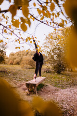 Woman practicing yoga and stretching on the park bench