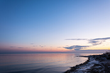 December sunrise with a beach and sea bay in the background