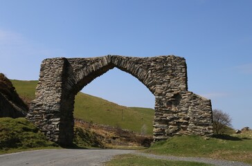 Fototapeta na wymiar The King George III Jubilee Arch spanning the old road from Devil's Bridge to Cwmystwyth, Ceredigion, Wales, UK.
