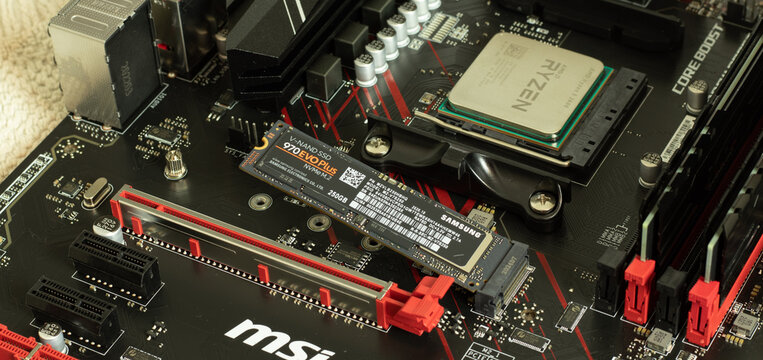 Moscow, Russia - 5 December 2020: Ryzen CPU in socket of MSI motherboard with Samsung SSD memory close-up, Illustrative Editorial