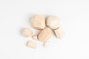 Start of the game tumi-ishi. Stones for Rock Balance. Randomly scattered wooden elements for a puzzle game in which you have to build a tower from polyhedral pieces of wood.