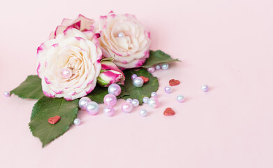 delicate bouquet of bushy peony roses with bright ribbons, pearls, feathers on a pink background, the concept of congratulations on Valentine's day