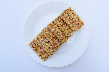 Selective focus closeup of mungfali gajak or peanut chkki an Indian traditional popular sweet made out of Sesame seeds and jaggery. Famous Sankranti festival dessert arranged
