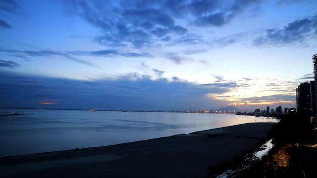 Time lapse sunrise with moving cloud at Penang Gurney Drive overseeing the sea front