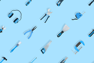 Tools seamless pattern. Various construction tools on a blue background.