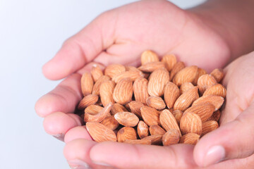 top view of almond nuts on man's hand 
