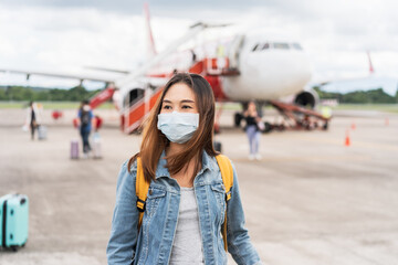 Young woman wearing a face mask at the airport, New normal lifestyle concept