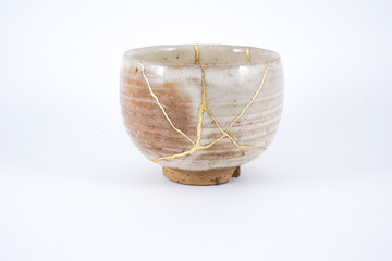 Antique beige Japanese cup restored with real gold Kintsugi technique.
