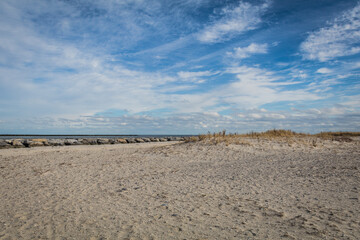 Beach and sand dunes at Barnegat, NJ, on a brisk winter day under blue cloudy sky