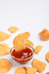 Potato chips with tomato ketchup isolated on white background