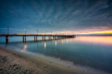 Obraz premium Wooden pier in Mechelinki village before sunrise, northern Poland.
