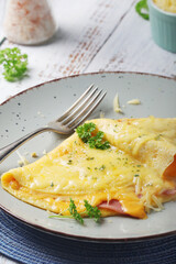 Omelette with ham and cheese on the plate
