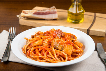 bucatini or spaghetti all'amatriciana are a typical pasta dish of the culinary tradition of Rome and the Lazio region in Italy prepared with pancetta and tomato sauce