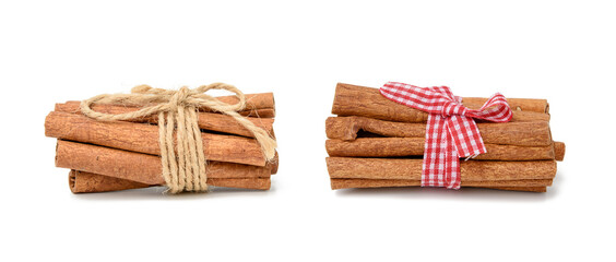 dry cinnamon sticks tied with red ribbon, spice isolated on white background