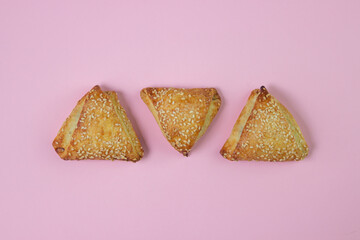 Sweet pastries on a pink background. Homemade sweets. Baking with sesame seeds.